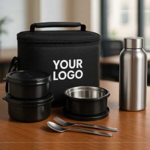 dark grey microwave safe lunchbox with bottle spoon fork displayed on office table