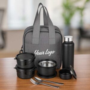 grey microwave safe lunchbox with bottle spoon fork displayed on office table