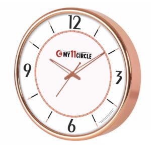 Introducing a stylish and high-impact rosegold promotional clock, designed to capture attention in any modern setting. This 10.5-inch round timepiece leverages the contemporary appeal of rosegold foiling on its frame and hands, instantly adding a touch of chic elegance to offices, homes, or retail environments. More than just a clock, it serves as a sophisticated branding tool. Its attractive design ensures it will be displayed prominently, offering constant, positive exposure for your brand. This rosegold promotional clock is an ideal choice for businesses that value modern aesthetics and effective brand placement. Features & Specifications This wall clock is crafted for both style and practicality. The defining feature is the beautiful Rosegold Foiling, which gives the entire clock a premium, fashionable look. The dial is designed for clarity, utilizing prominent Arabic numerals at the quarter positions (12, 3, 6, and 9) and clear dash markers for the remaining hours. The circular print area for Custom Branding is a sizable 254 mm round, offering sufficient space to clearly display Your Logo or campaign message without cluttering the face. The 10.5" round size makes it versatile for a variety of spaces, and its light Gross Weight of 755 Gms makes it easy to handle and mount. It’s packaged optimally for wholesale distributors and bulk order clients, with 40 units per Master Packing carton, ensuring streamlined logistics. Uses & Benefits The trendy finish of this rosegold promotional clock makes it particularly appealing for corporate gifting buyers targeting younger audiences, creative industries, or executive women. It moves beyond the traditional and is guaranteed to be appreciated and displayed. Marketing teams can use it as a highly visible promotional product, placing the brand in influential client offices and common areas. Bulk order clients benefit from a contemporary product with broad appeal and high perceived value, making it a powerful item for large-scale giveaways or employee onboarding kits. Why Buy From Us We specialize in high-quality custom wall clocks that combine modern design with flawless execution of Your Logo. Our expertise in rosegold foiling ensures a perfect, lasting finish. We provide excellent support and competitive pricing for bulk orders, enabling distributors and branding teams to execute large campaigns efficiently. Choose us for a premium promotional clock that reflects the sophistication and modernity of your brand.